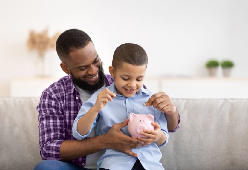 Father and son with savings bank