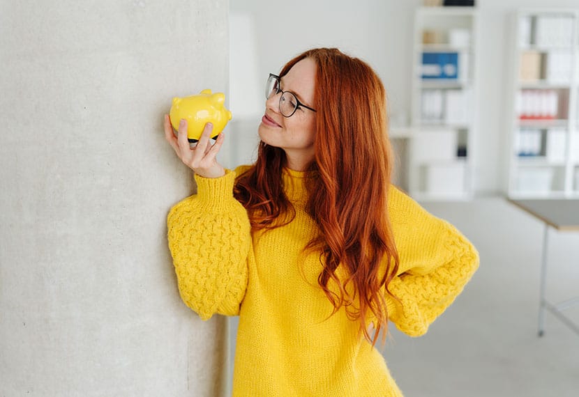 woman holding piggybank